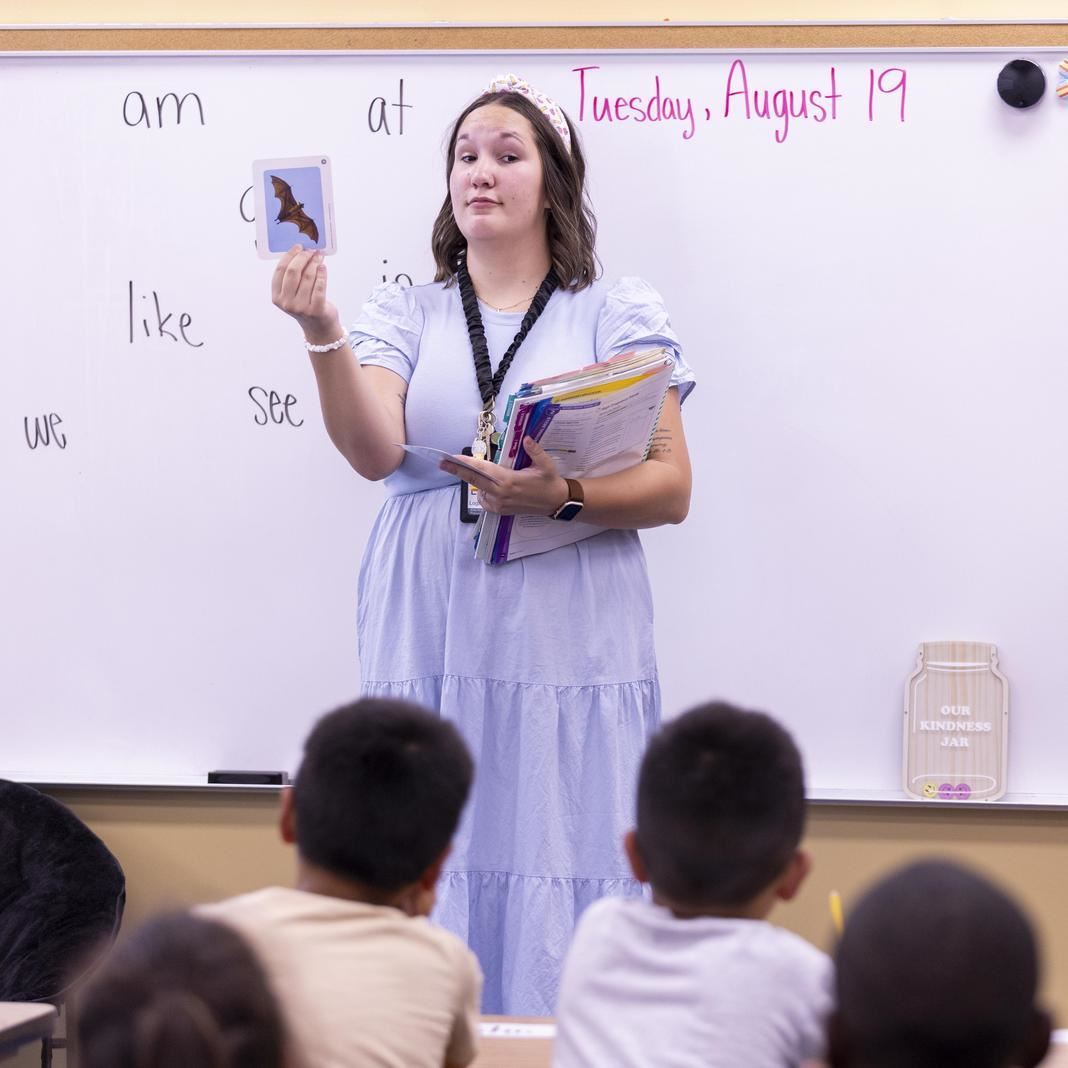  Logan Ericson holds up a flash card in front of her class